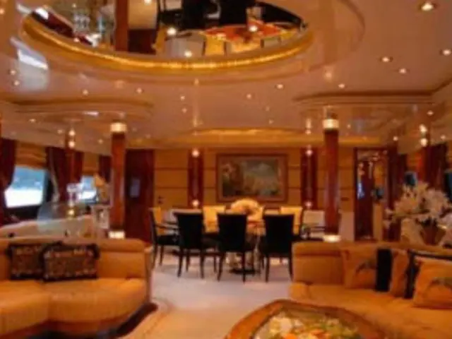 This is a picture of a hotel. In the foreground of the picture there are couches, pillows, chairs,...